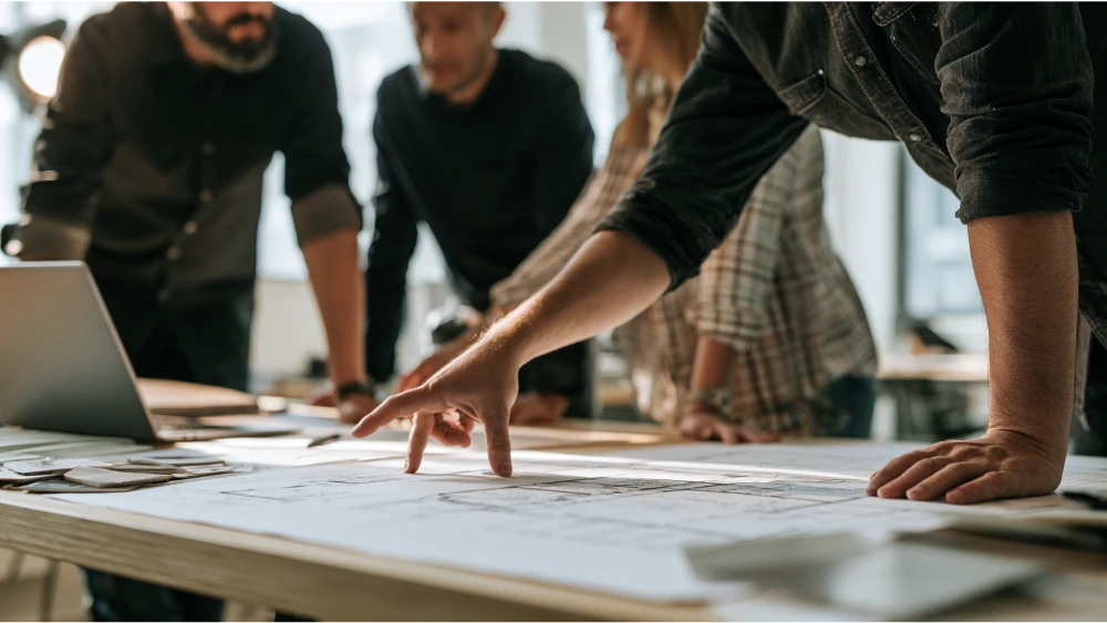 Homeowners reviewing home addition plans with designer